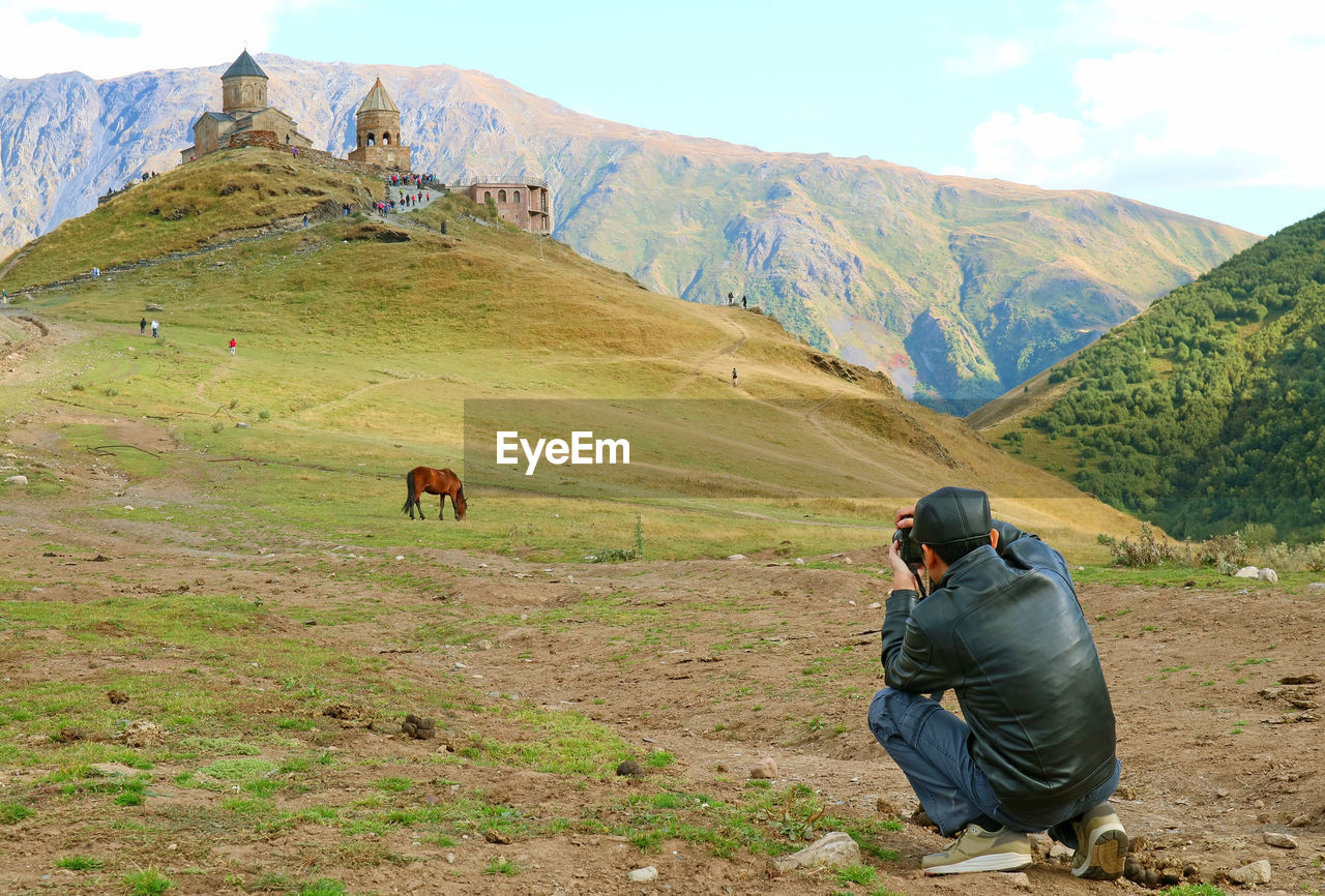 High angel view of man photographing on field