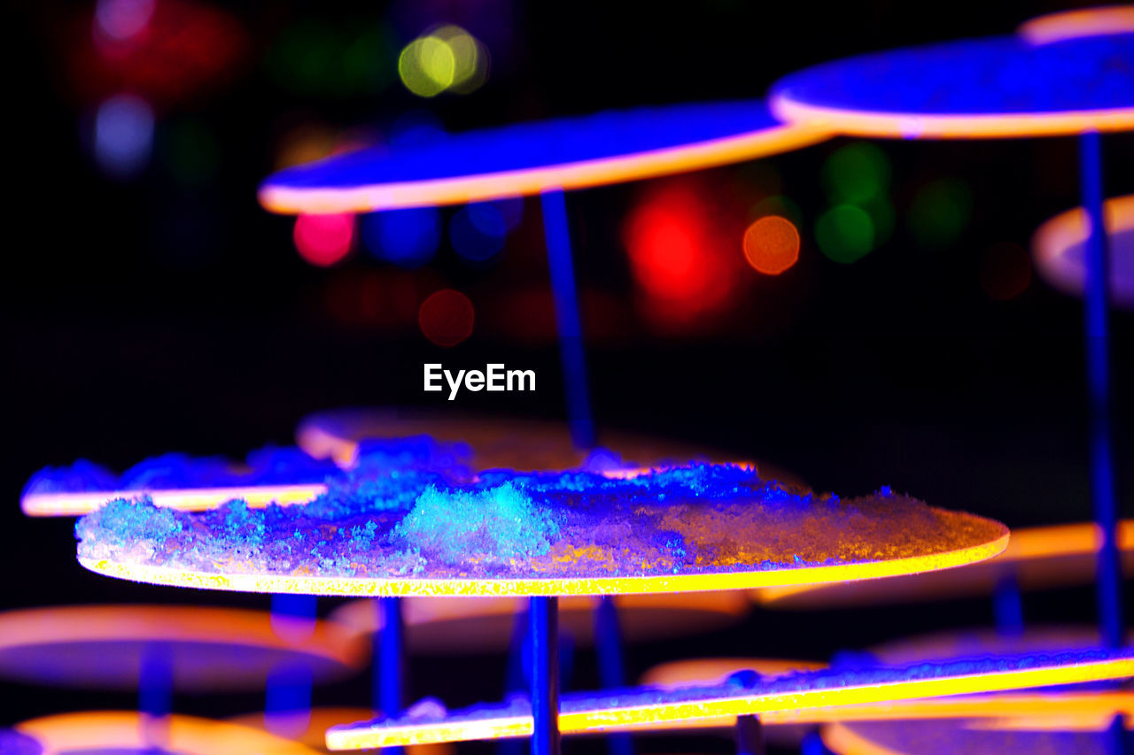 Close-up of crushed ice on illuminated table