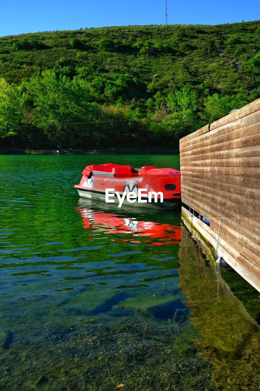 water, transportation, nautical vessel, mode of transportation, nature, boat, plant, sea, vehicle, boating, day, no people, sky, tree, moored, waterway, beauty in nature, green, travel, scenics - nature, outdoors, coast, reflection, watercraft, clear sky, non-urban scene, land, red, environment, tranquility, blue, reservoir, travel destinations, landscape, bay