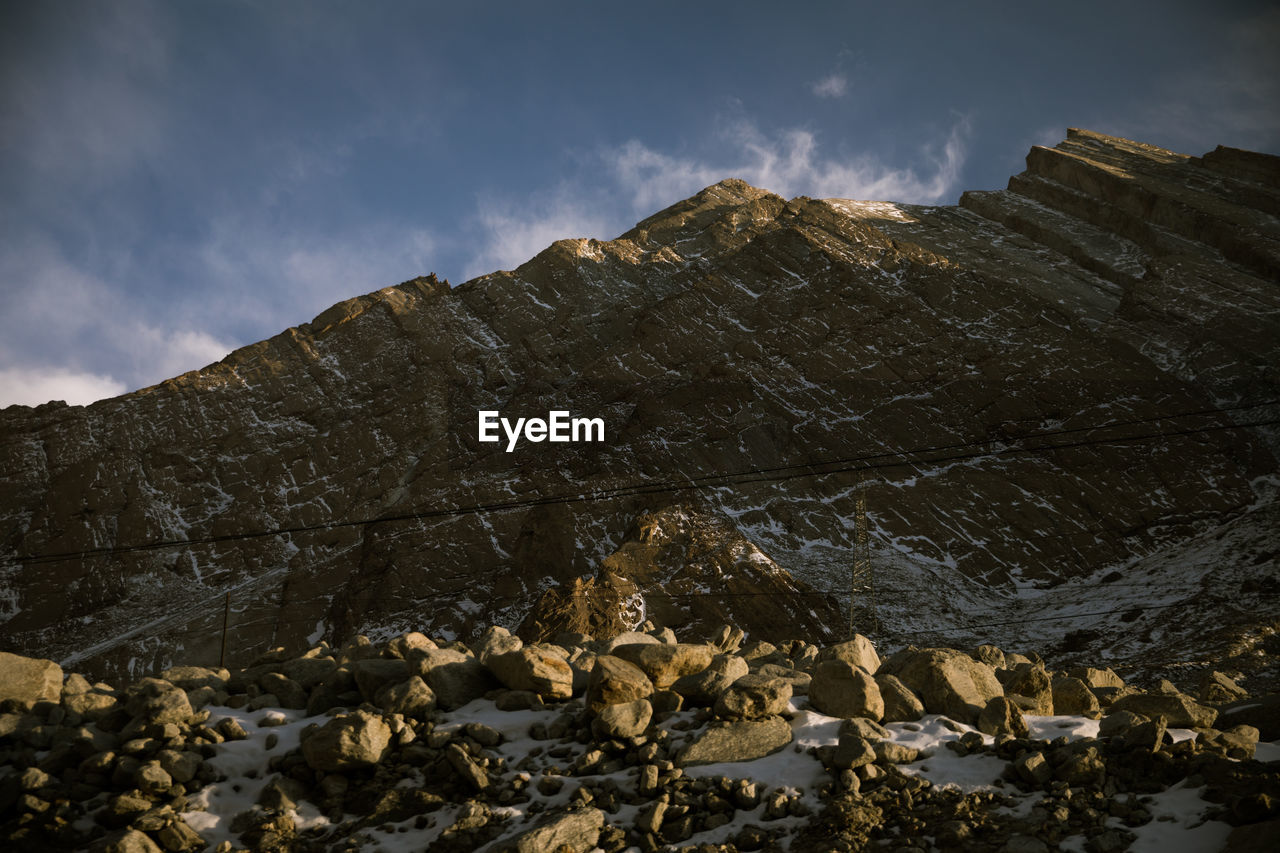 Low angle view of rocks against sky