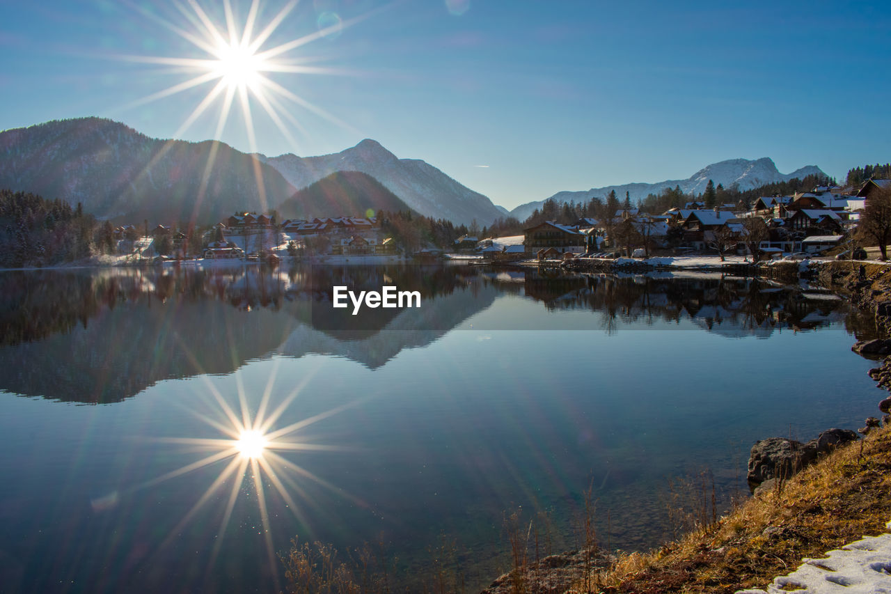 Scenic view of lake against sky on sunny day