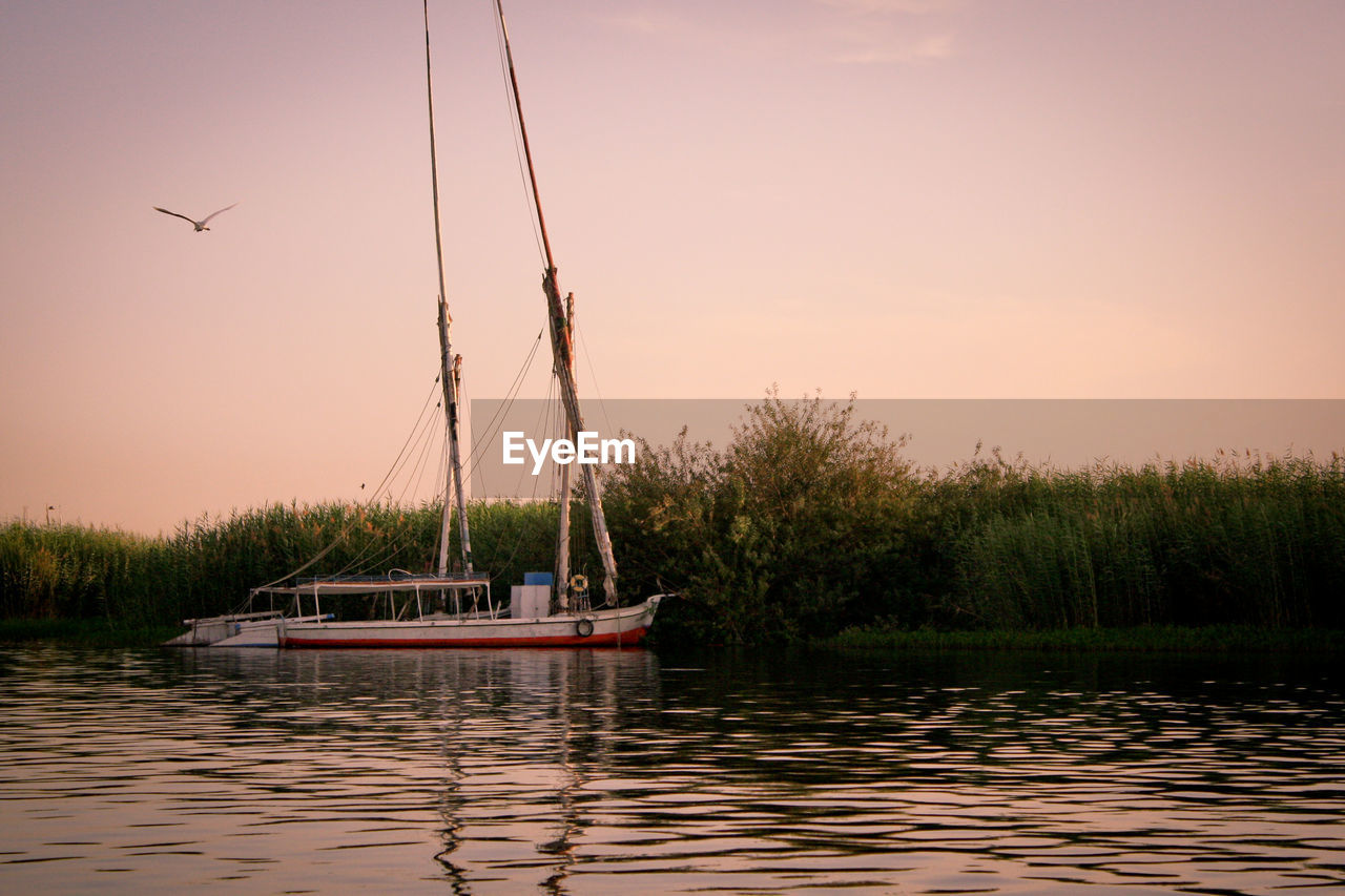 Boat in lake against sky