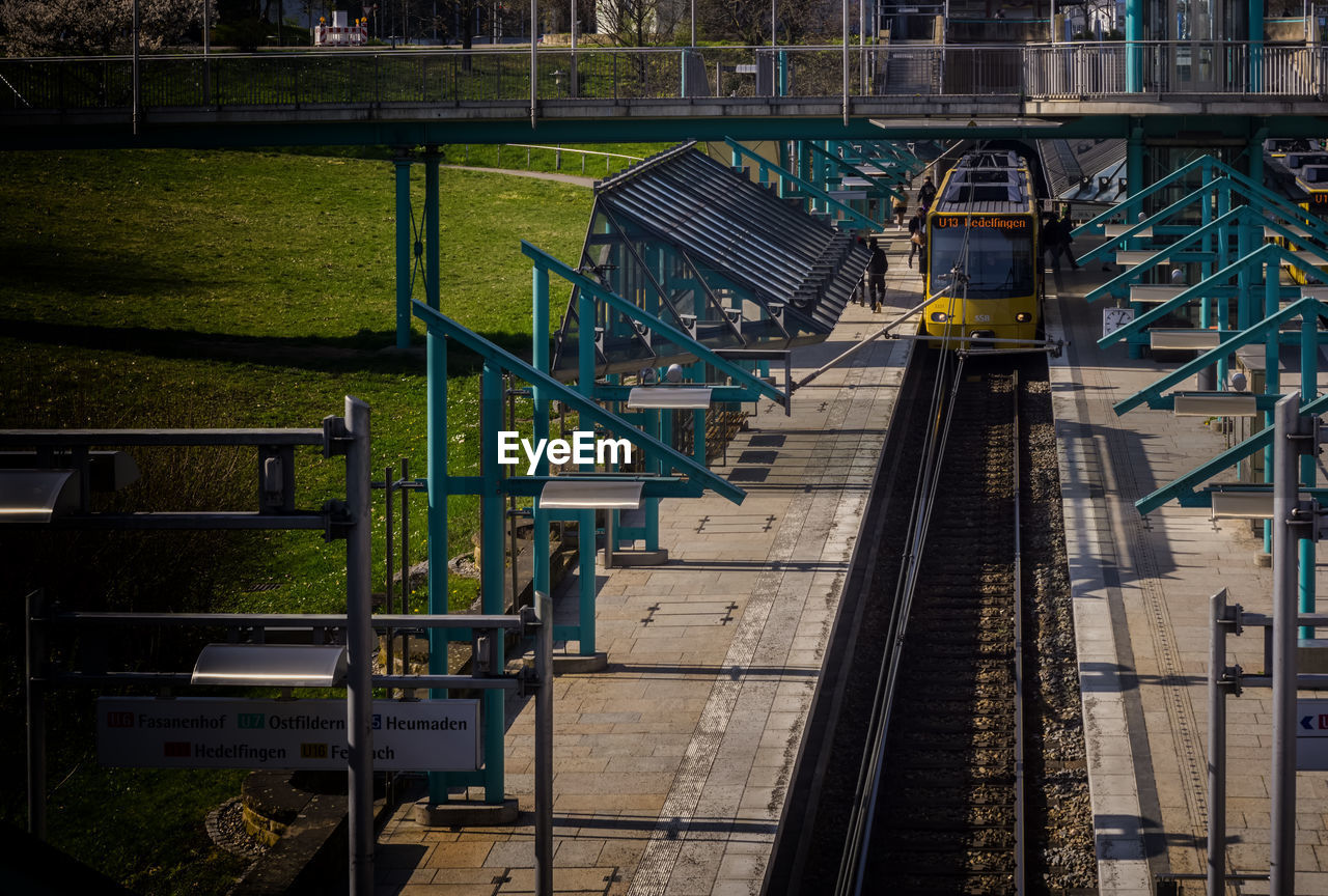 HIGH ANGLE VIEW OF RAILROAD TRACKS BY BUILDING