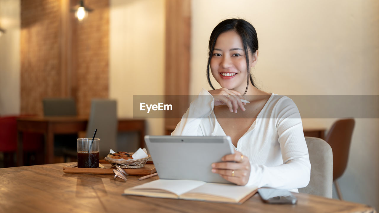 young woman using laptop while sitting at home