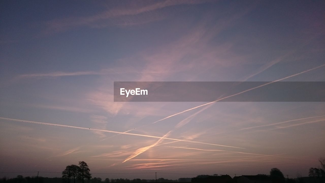 LOW ANGLE VIEW OF VAPOR TRAILS IN SKY