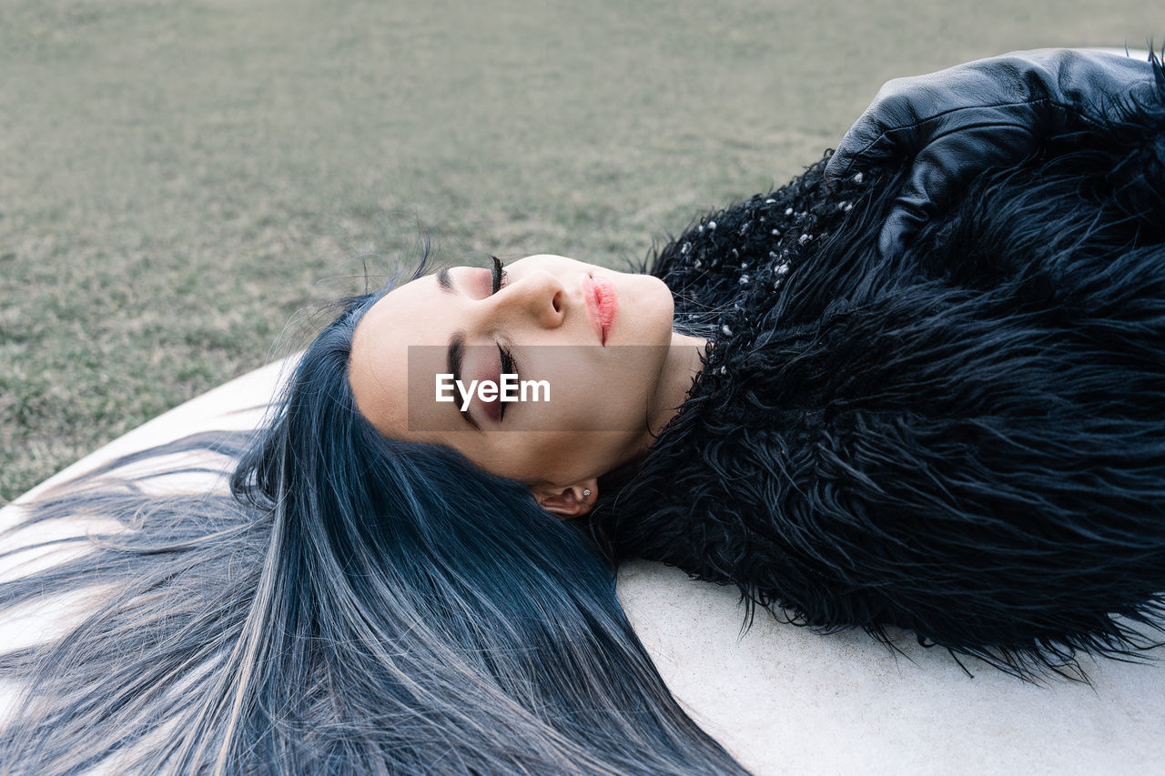 Portrait of young woman with blue hair