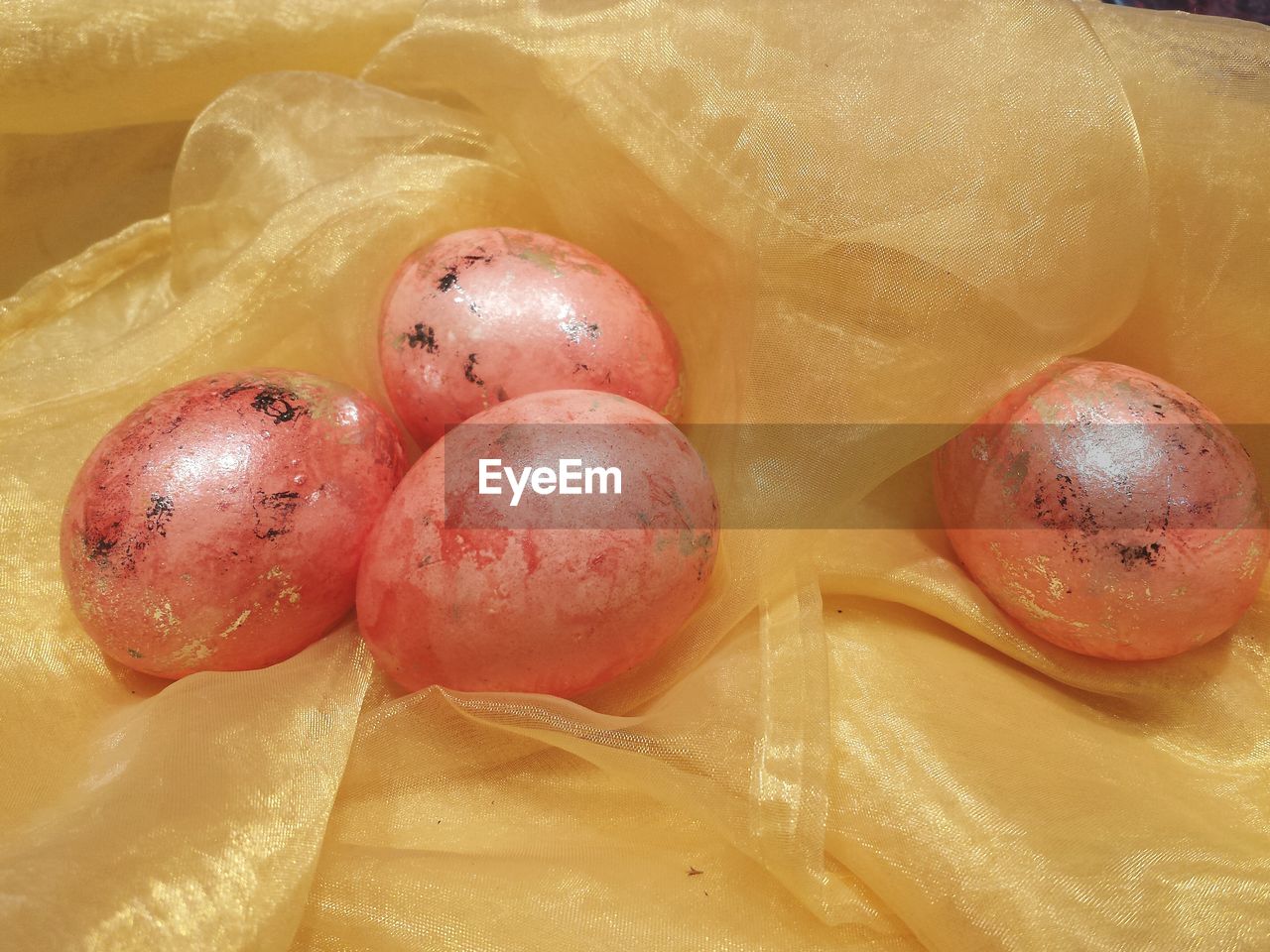 High angle view of easter eggs on golden fabric