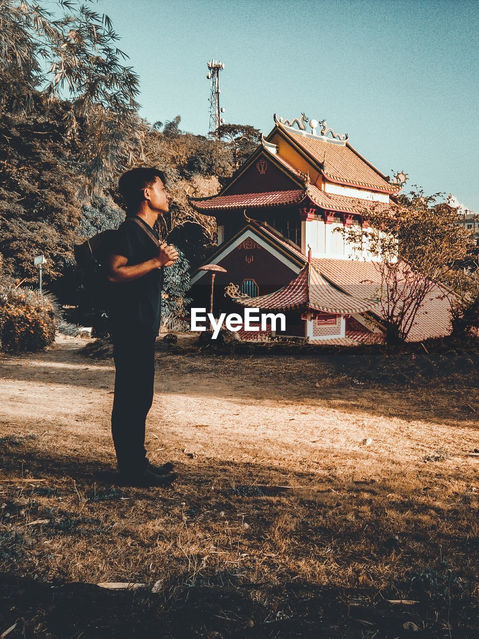 FULL LENGTH OF MAN STANDING AGAINST CLEAR SKY