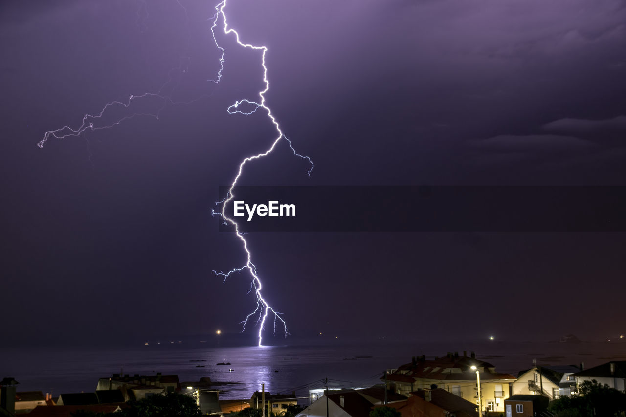 Low angle view of lightning in sky at night