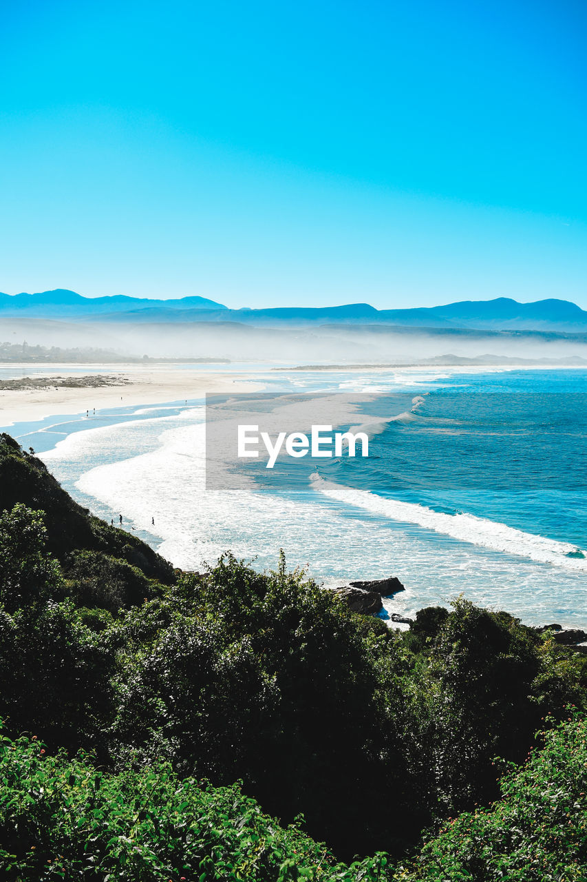 Scenic view of sea against clear blue sky