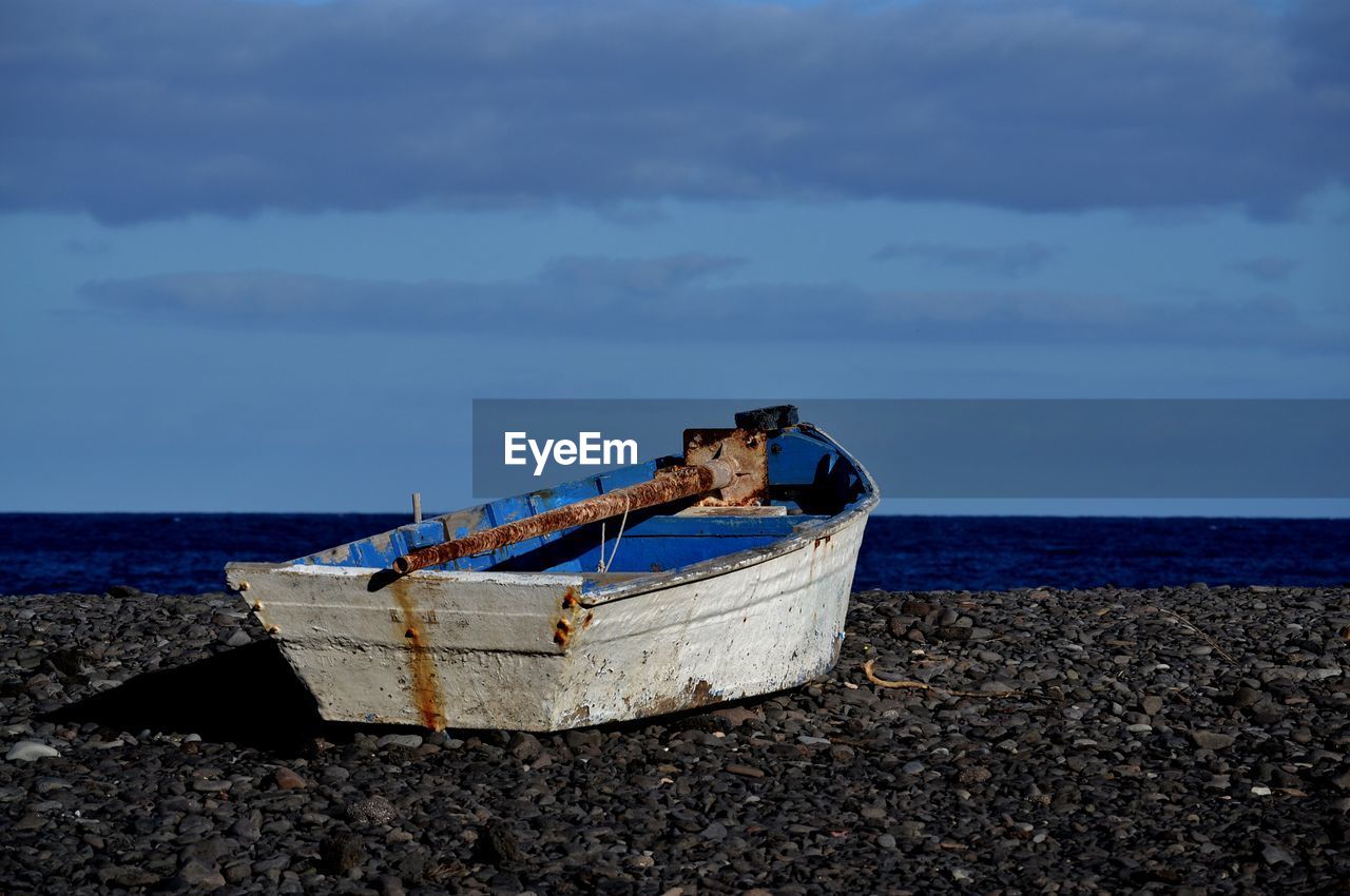 Boat on beach against sky