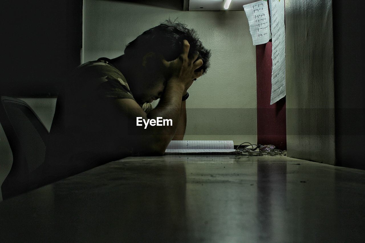 Side view of worried man at desk