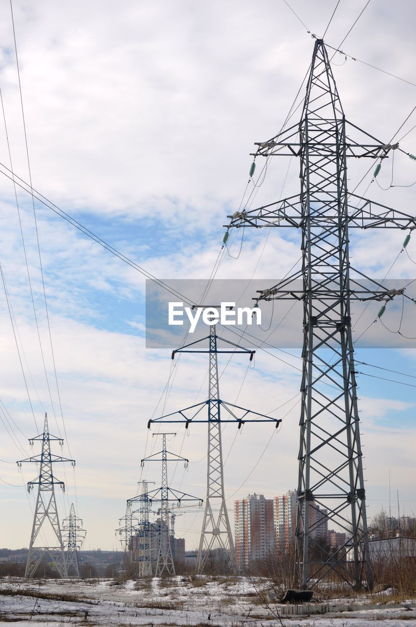 Low angle view of electricity pylon against sky