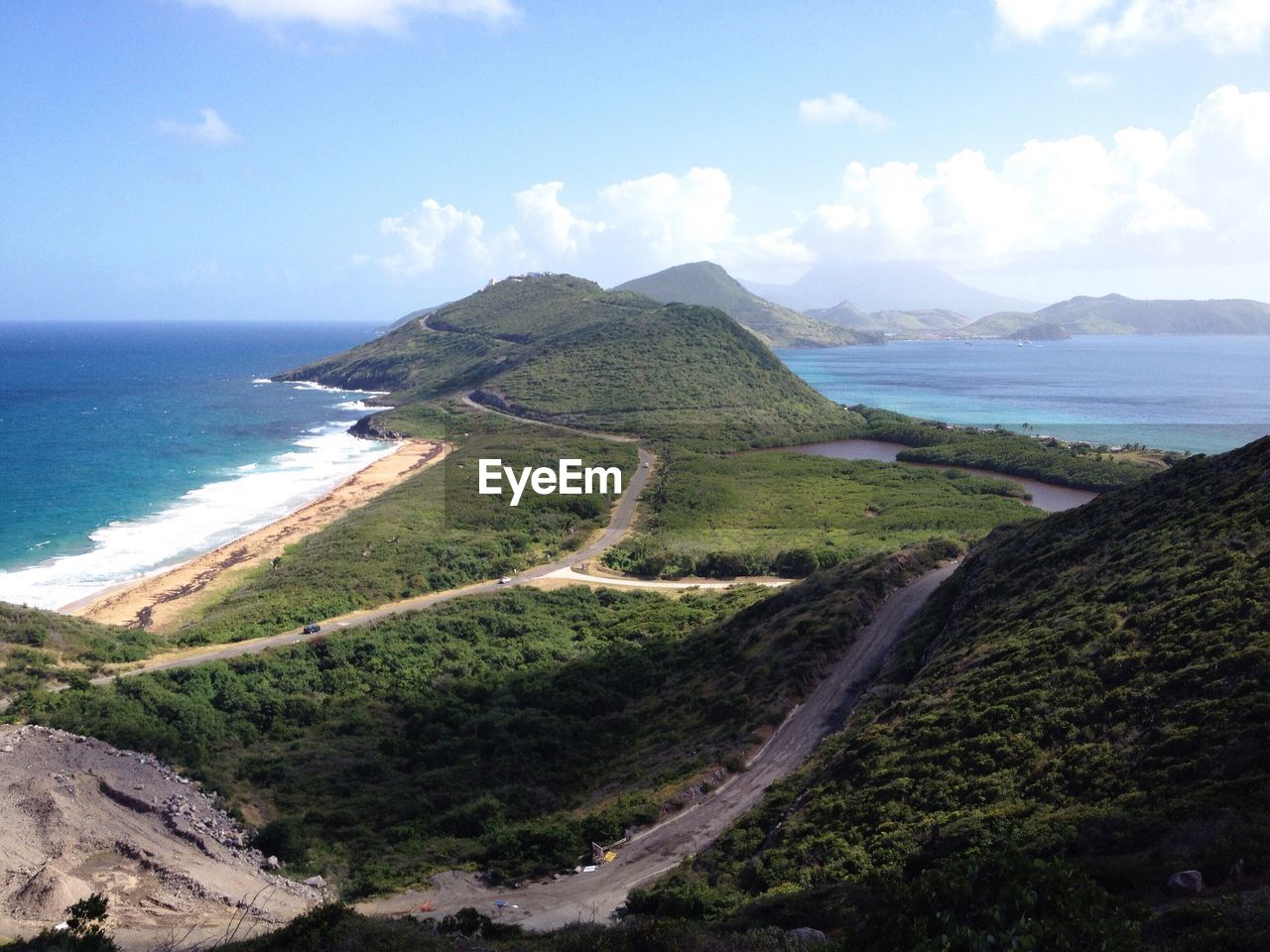 Scenic view of sea and mountains against sky