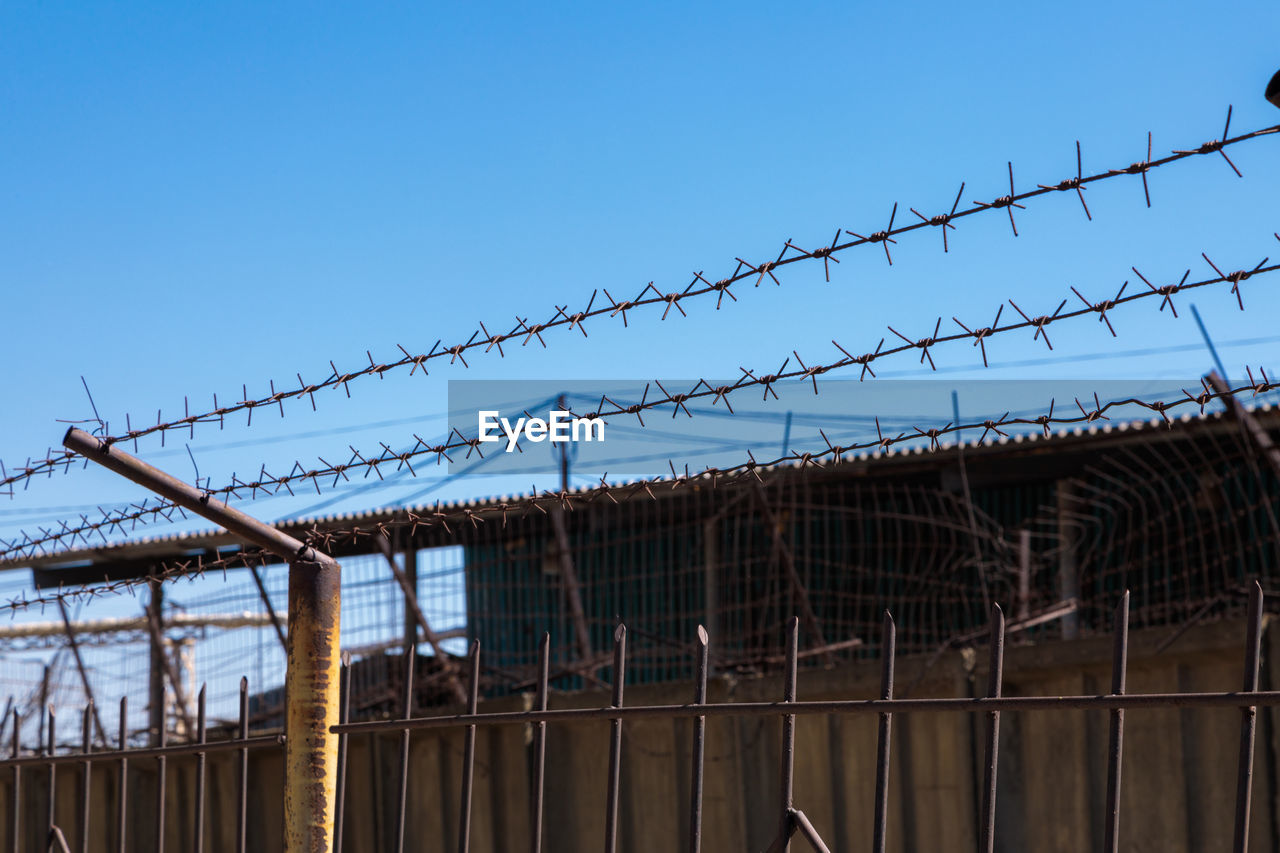 LOW ANGLE VIEW OF FENCE AGAINST CLEAR SKY