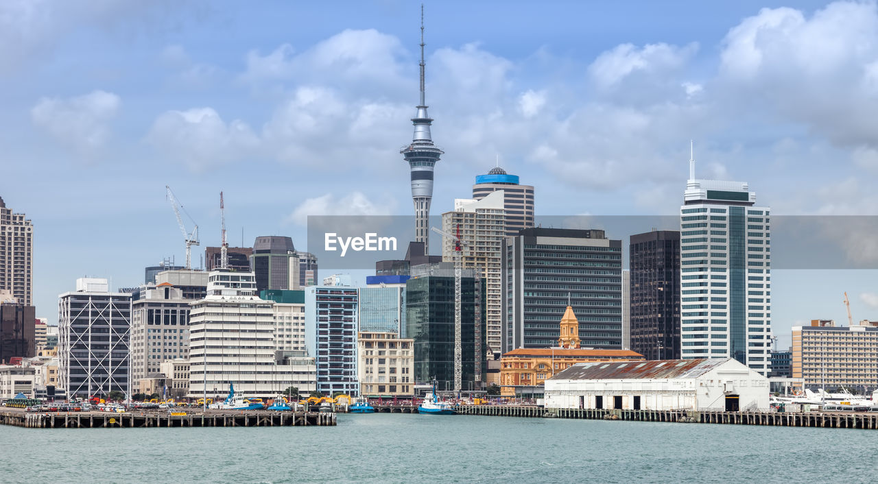 Buildings in city against cloudy sky