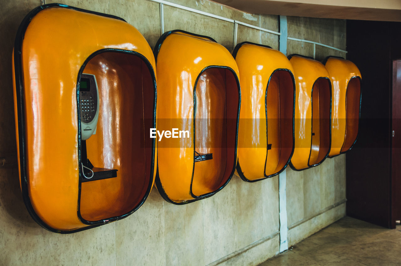 Yellow telephone booths on wall