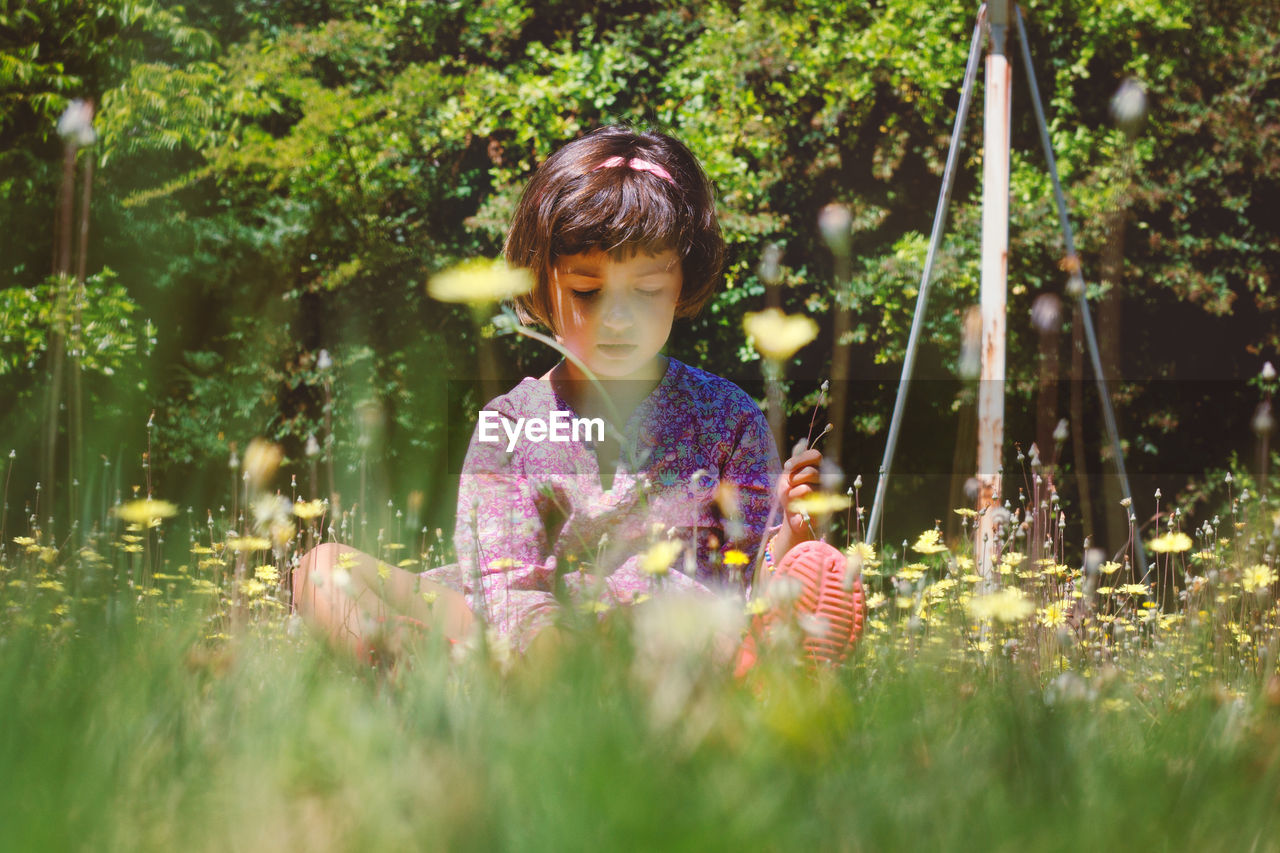 Close-up of girl with flowers in park