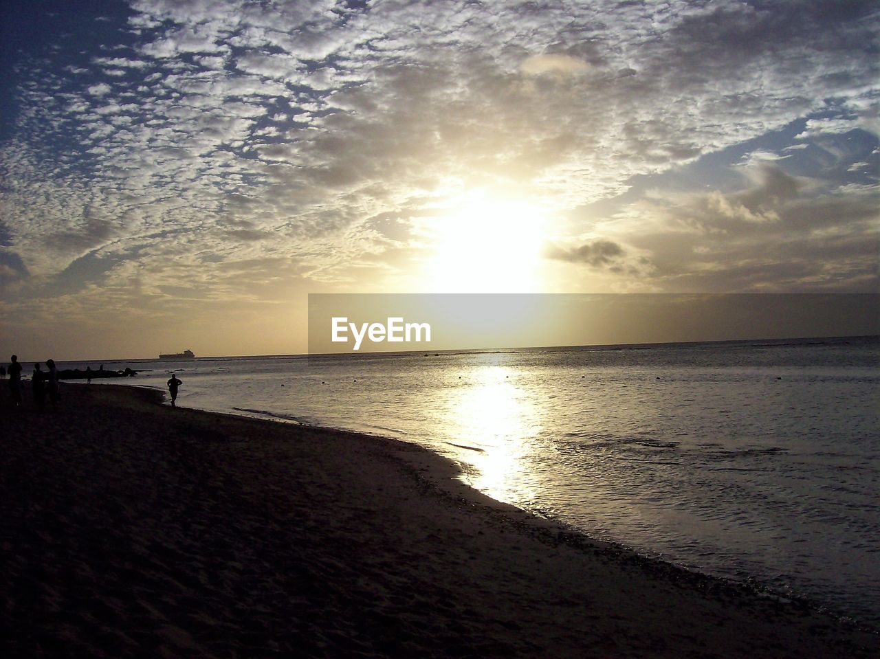 SCENIC VIEW OF BEACH DURING SUNSET