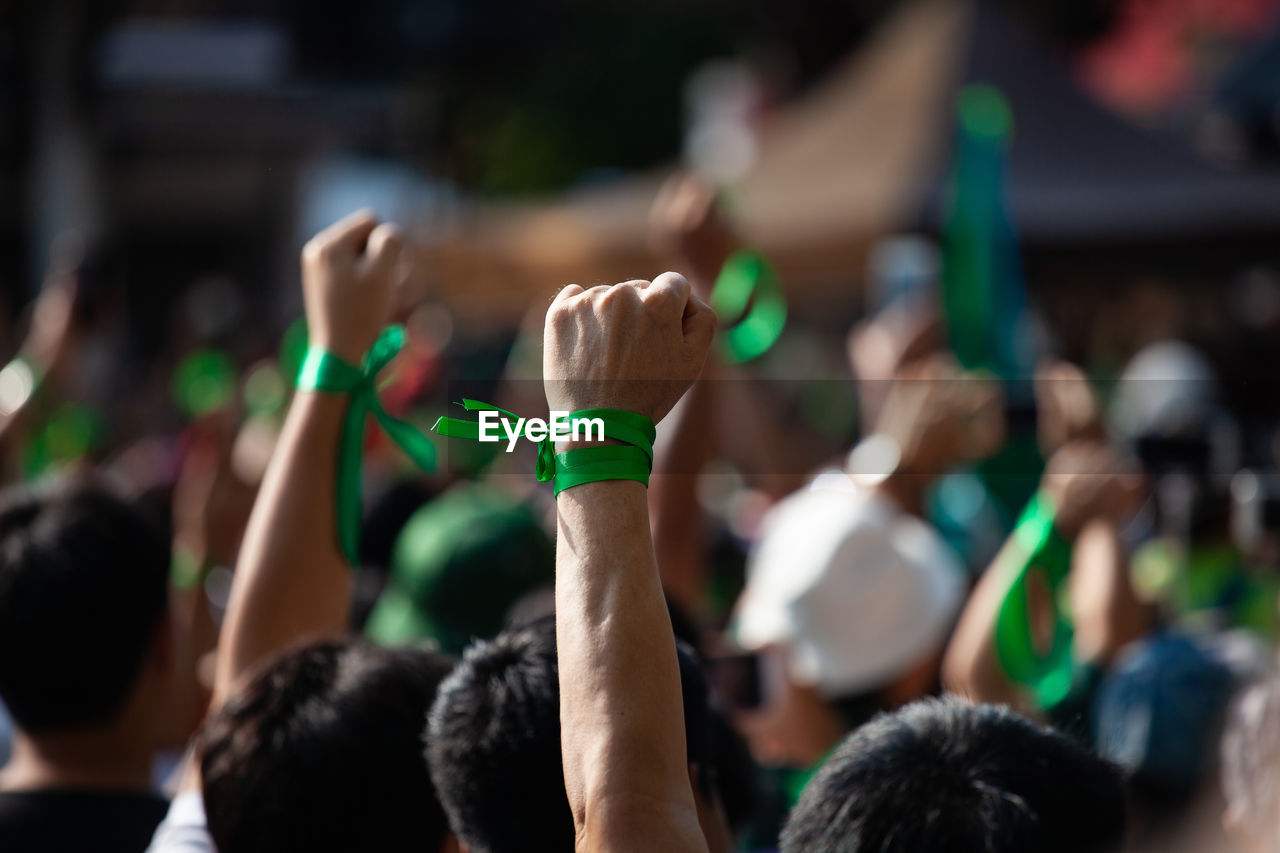 Rear view of people protesting outdoors