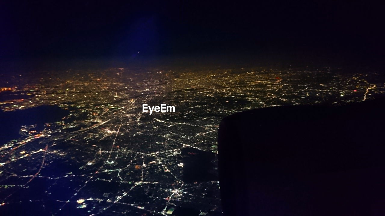 VIEW OF ILLUMINATED CITYSCAPE AT NIGHT