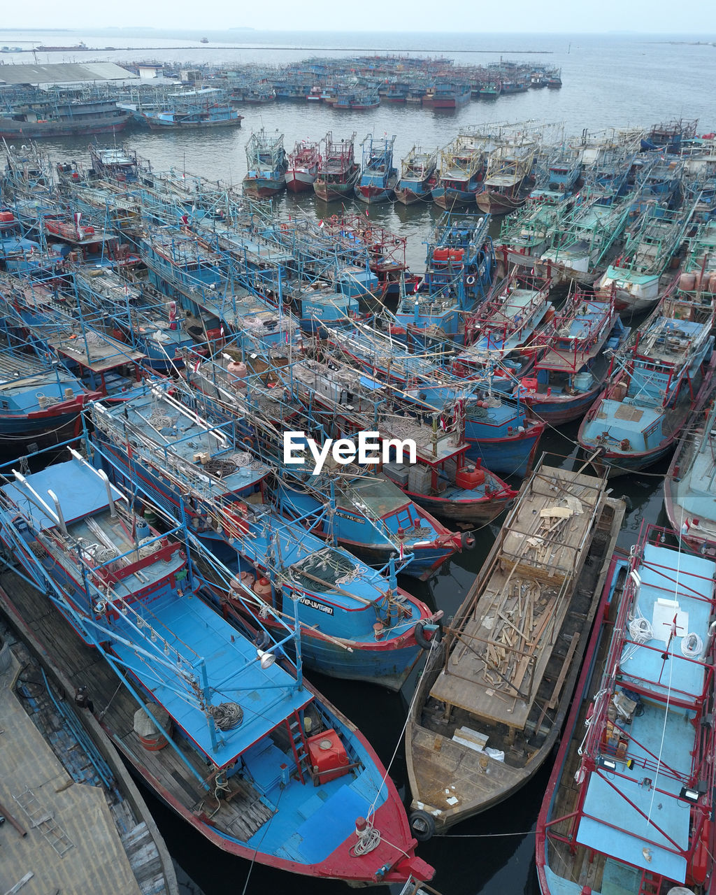 HIGH ANGLE VIEW OF FISHING BOATS MOORED IN HARBOR