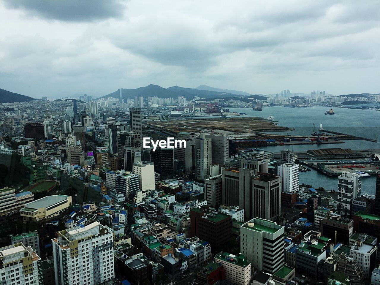 High angle view of cityscape against cloudy sky