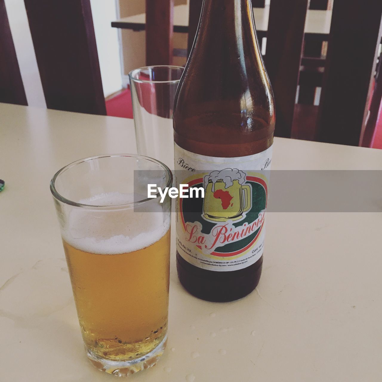 CLOSE-UP OF BEER GLASSES ON TABLE