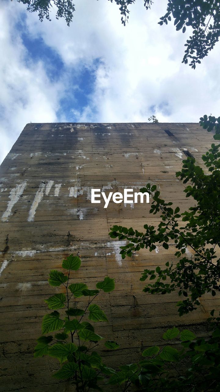 Low angle view of anti-aircraft bunker against cloudy sky