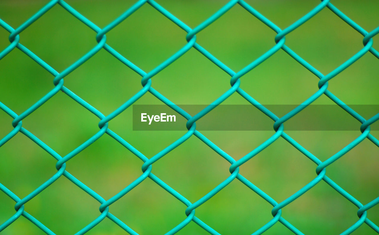 Close-up of chainlink fence at field