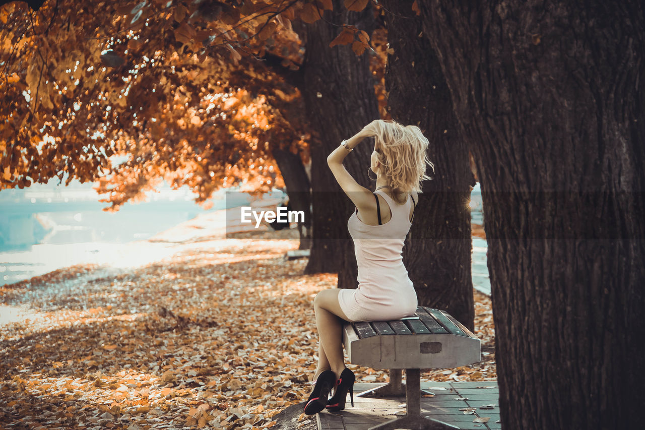 Young woman sitting on bench at park