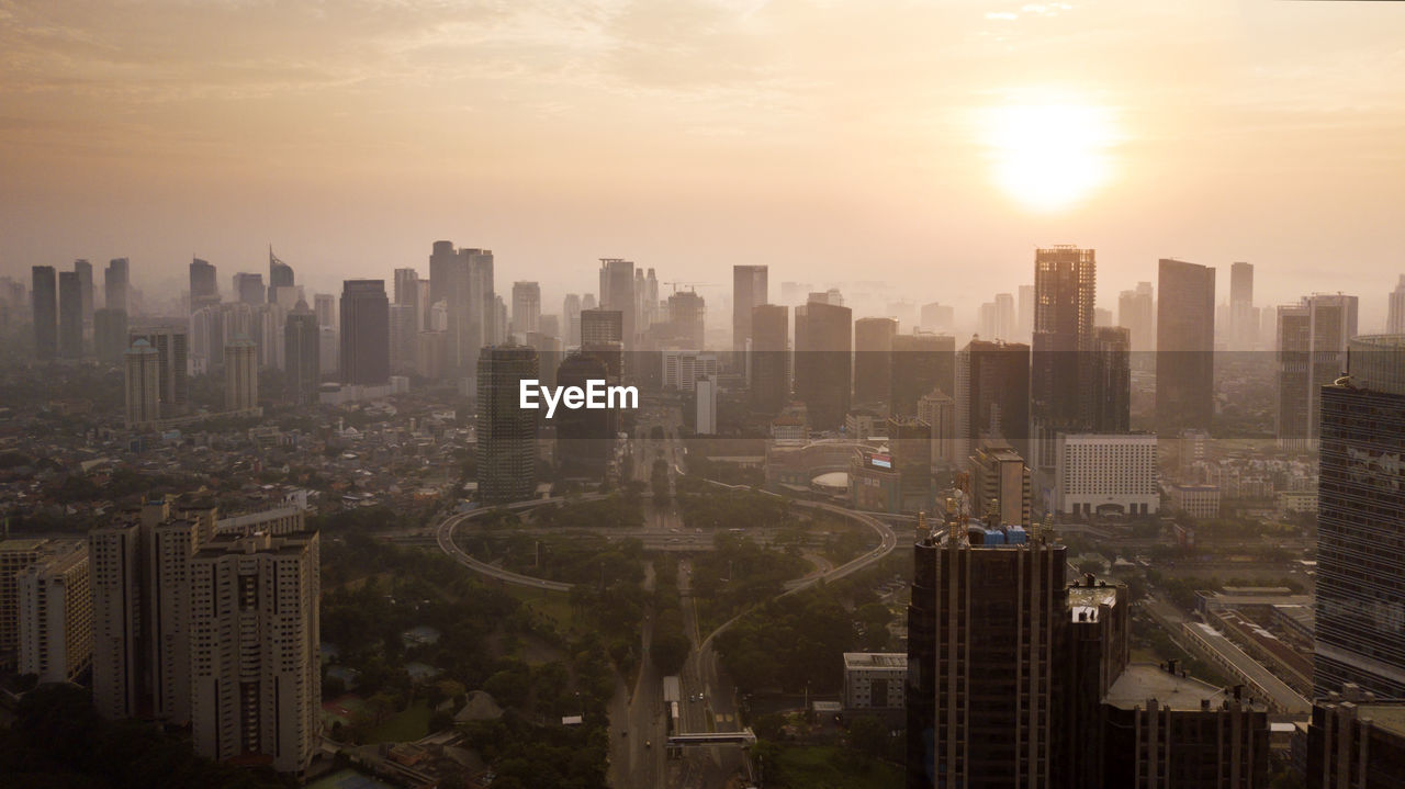 High angle view of buildings against sky during sunset