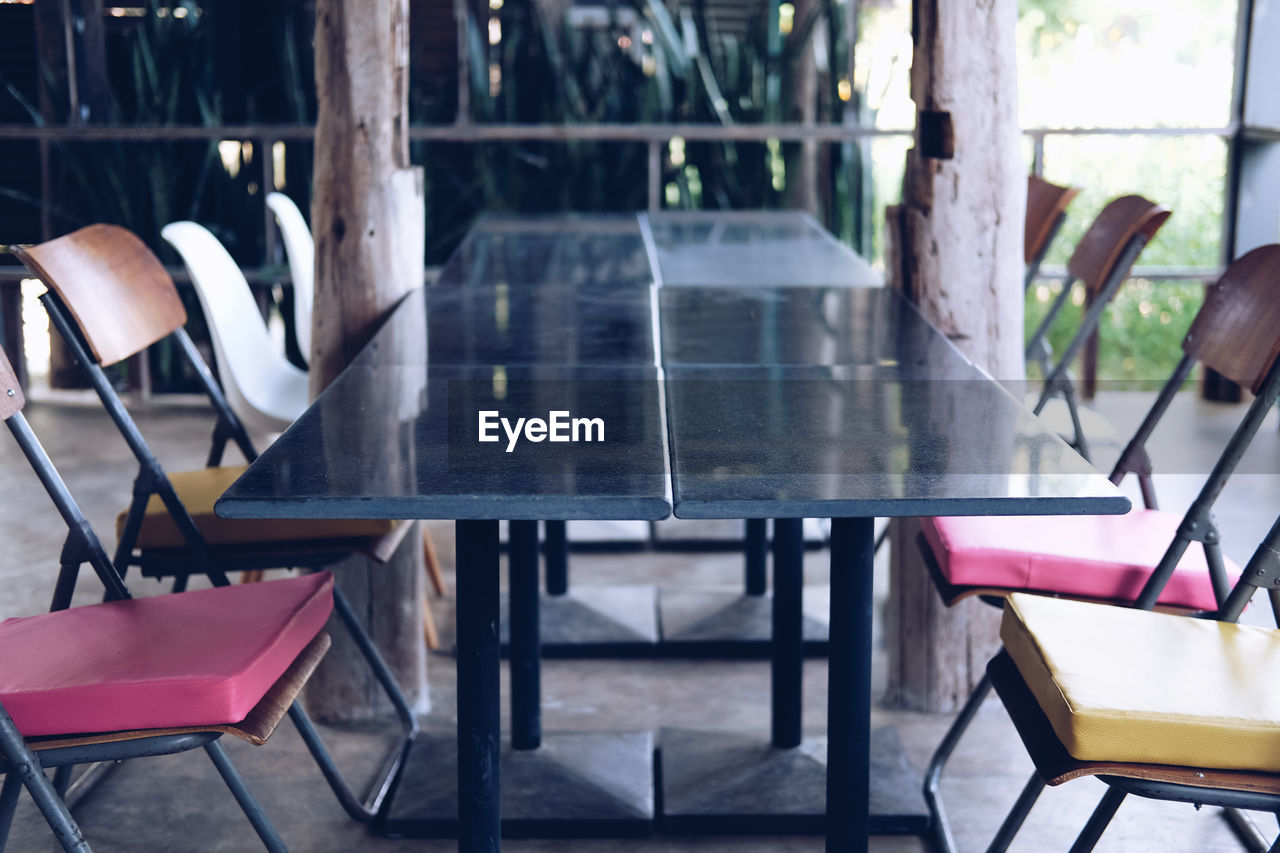 Empty chairs and tables in cafe