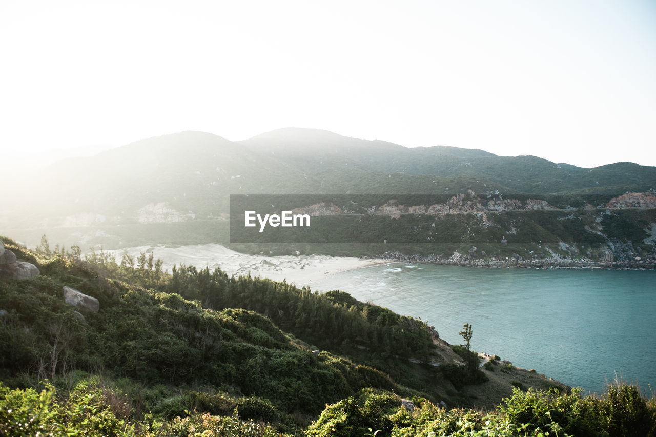 Scenic view of landscape and mountains against clear sky