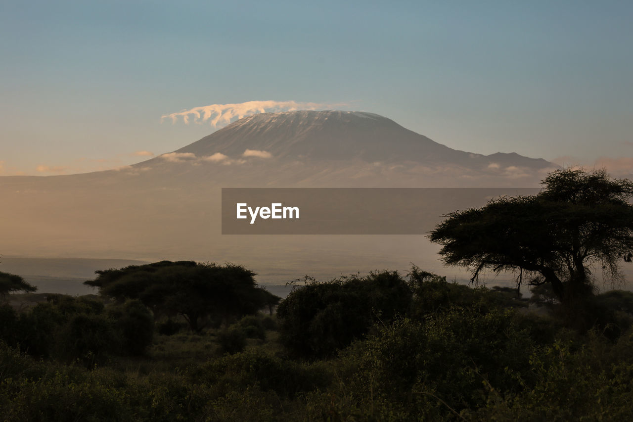 Scenic view of landscape against sky at sunset