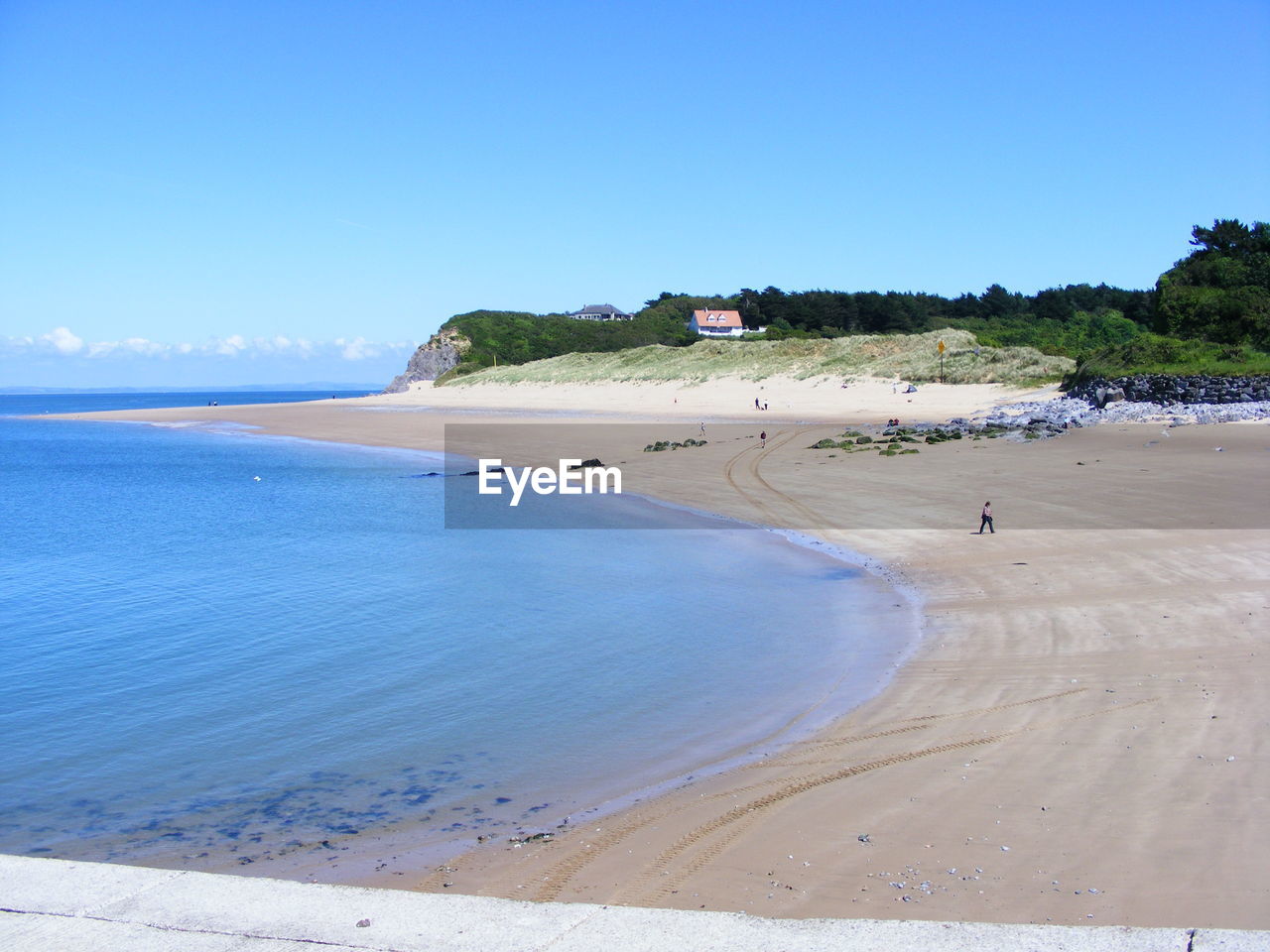 Scenic view of beach against clear blue sky