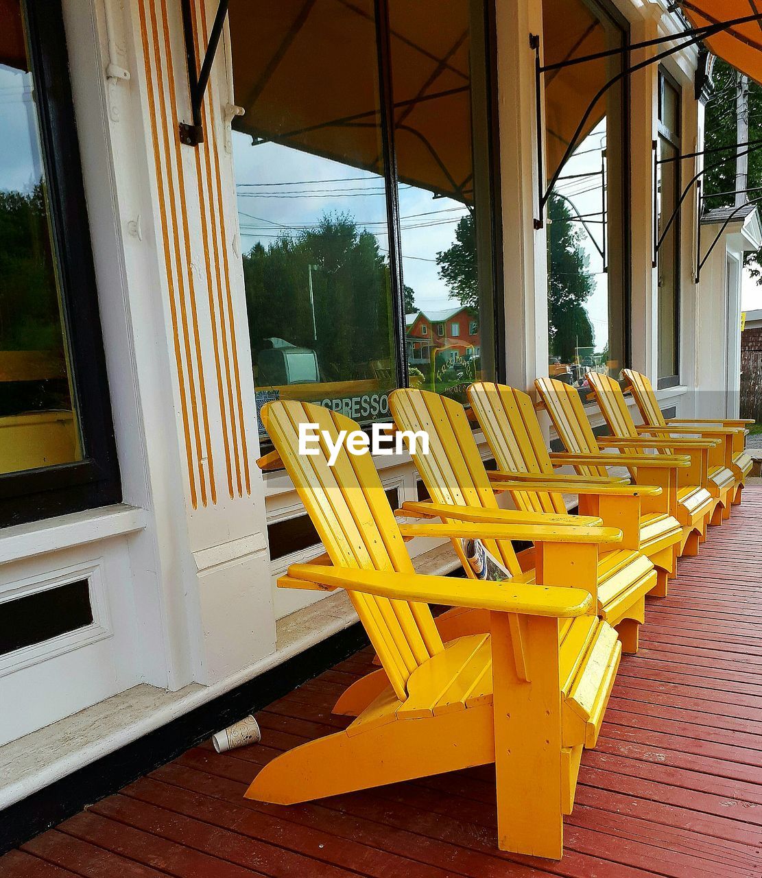 CLOSE-UP OF YELLOW CHAIR AGAINST SKY