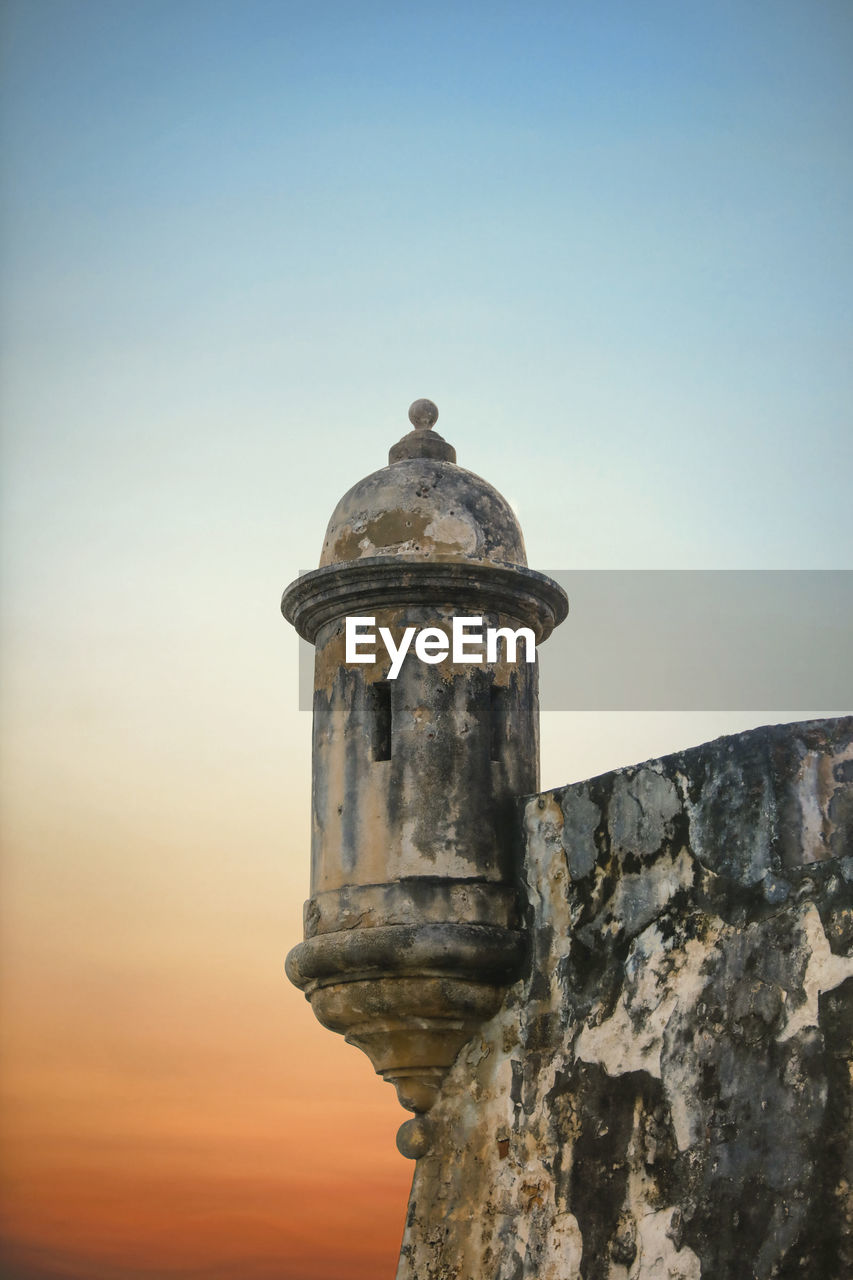 View of old building against clear sky during sunset