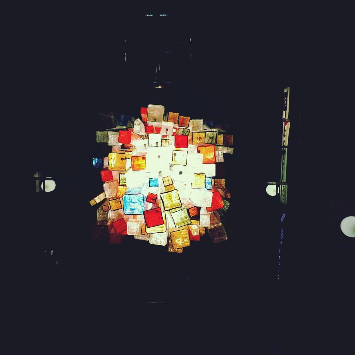 Directly below shot of illuminated colorful lanterns in darkroom