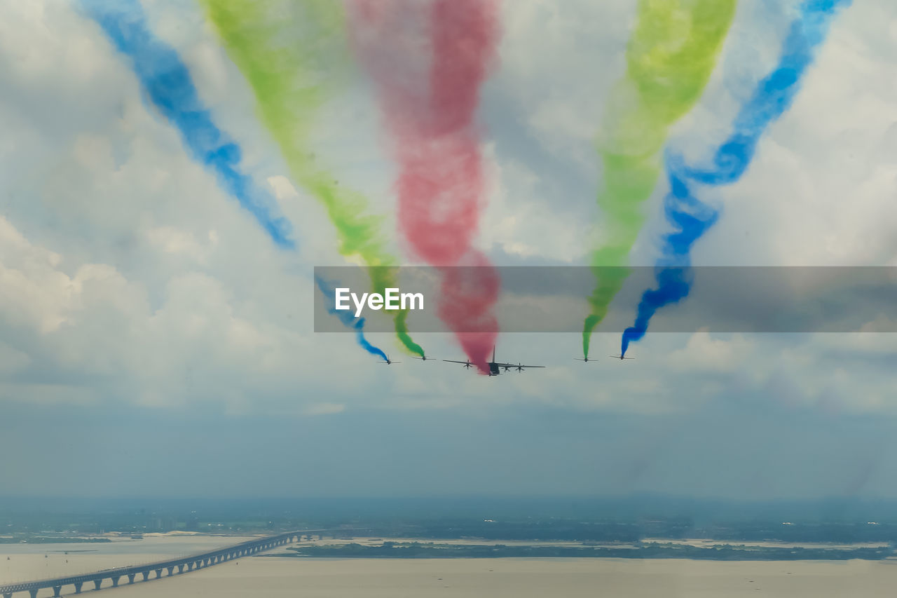 Scenic view of formation of airplanes coloring with sky with smokes in airshow over padma bridge 