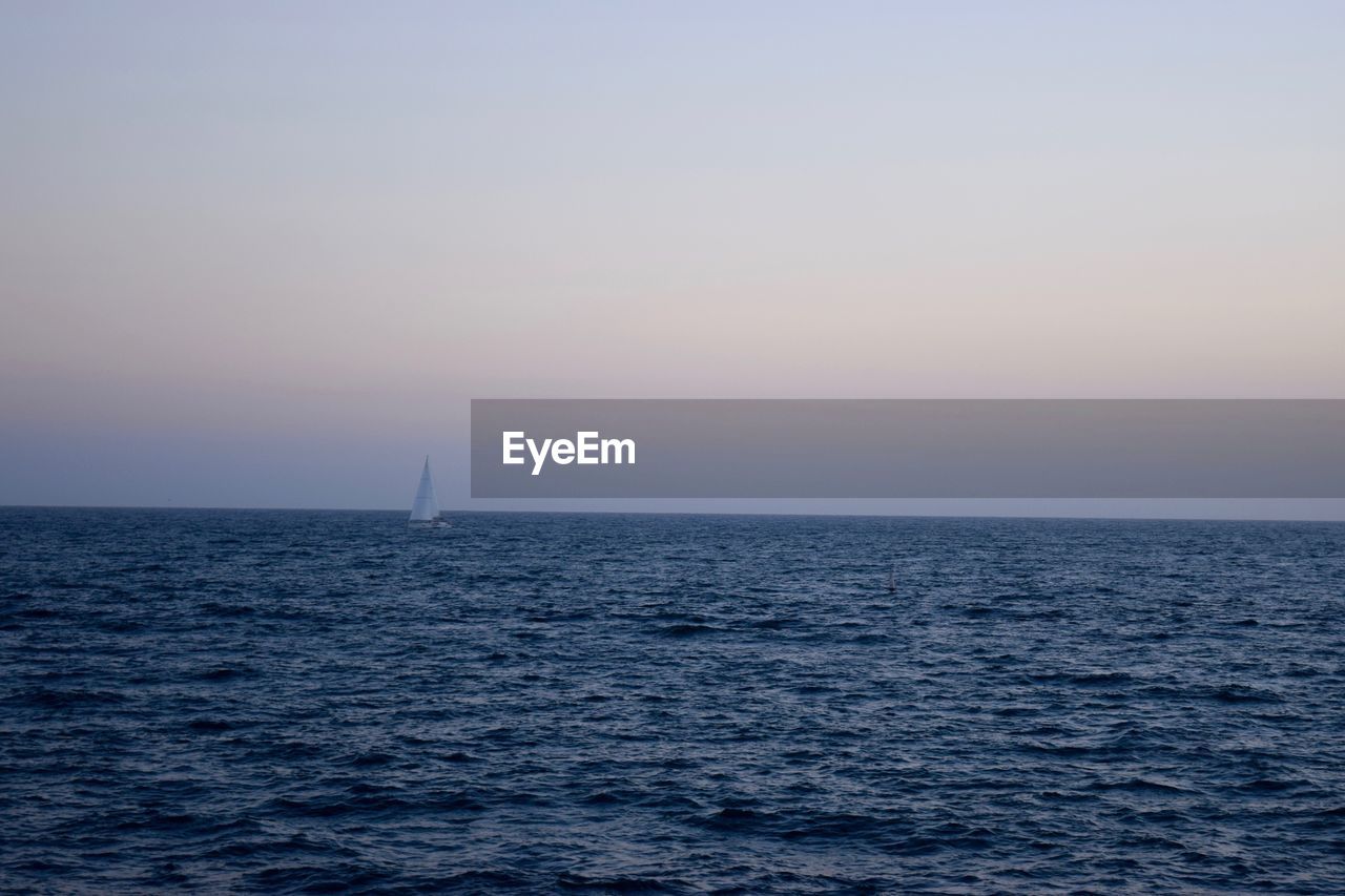 Scenic view of sea against clear sky during sunset