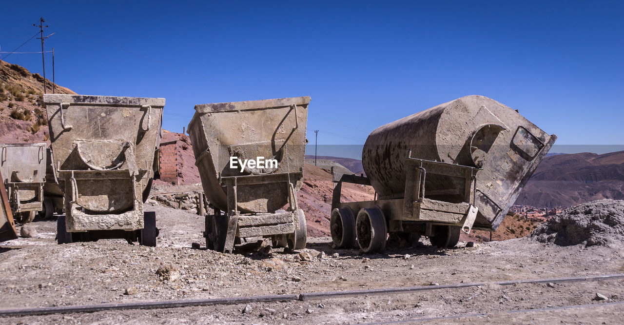 PANORAMIC VIEW OF ABANDONED CARS AGAINST CLEAR SKY