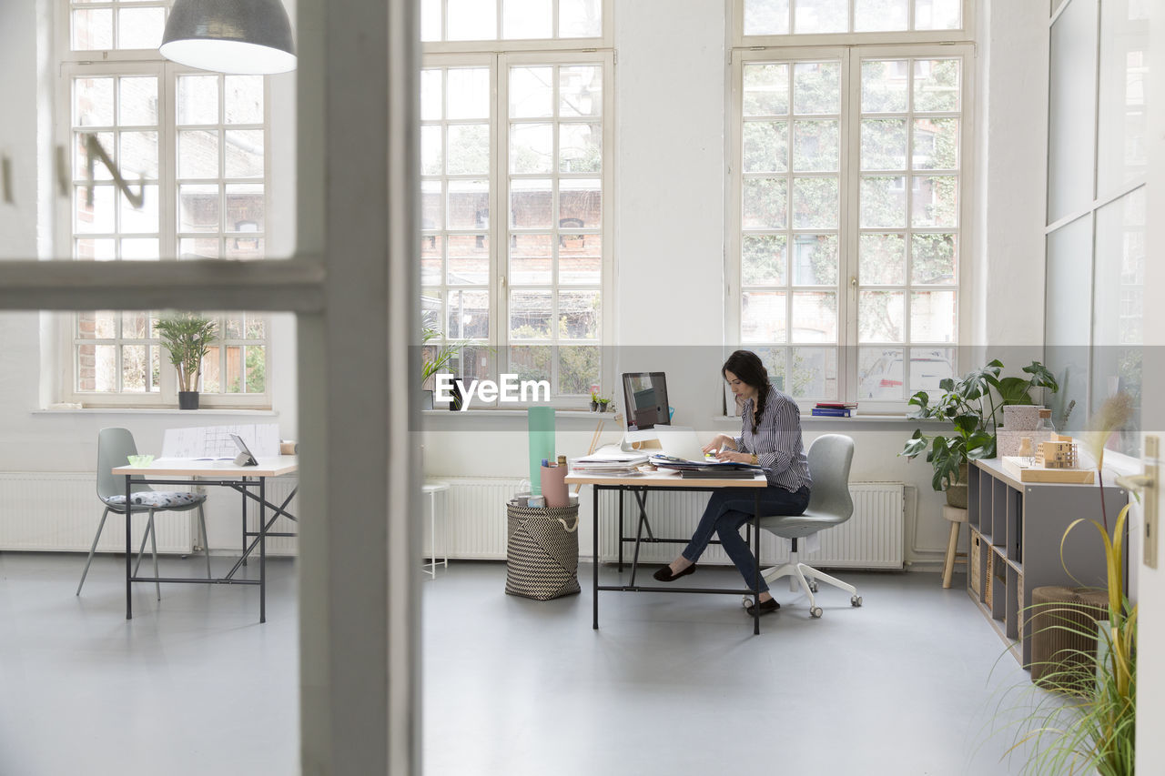 Woman working at desk in a loft office