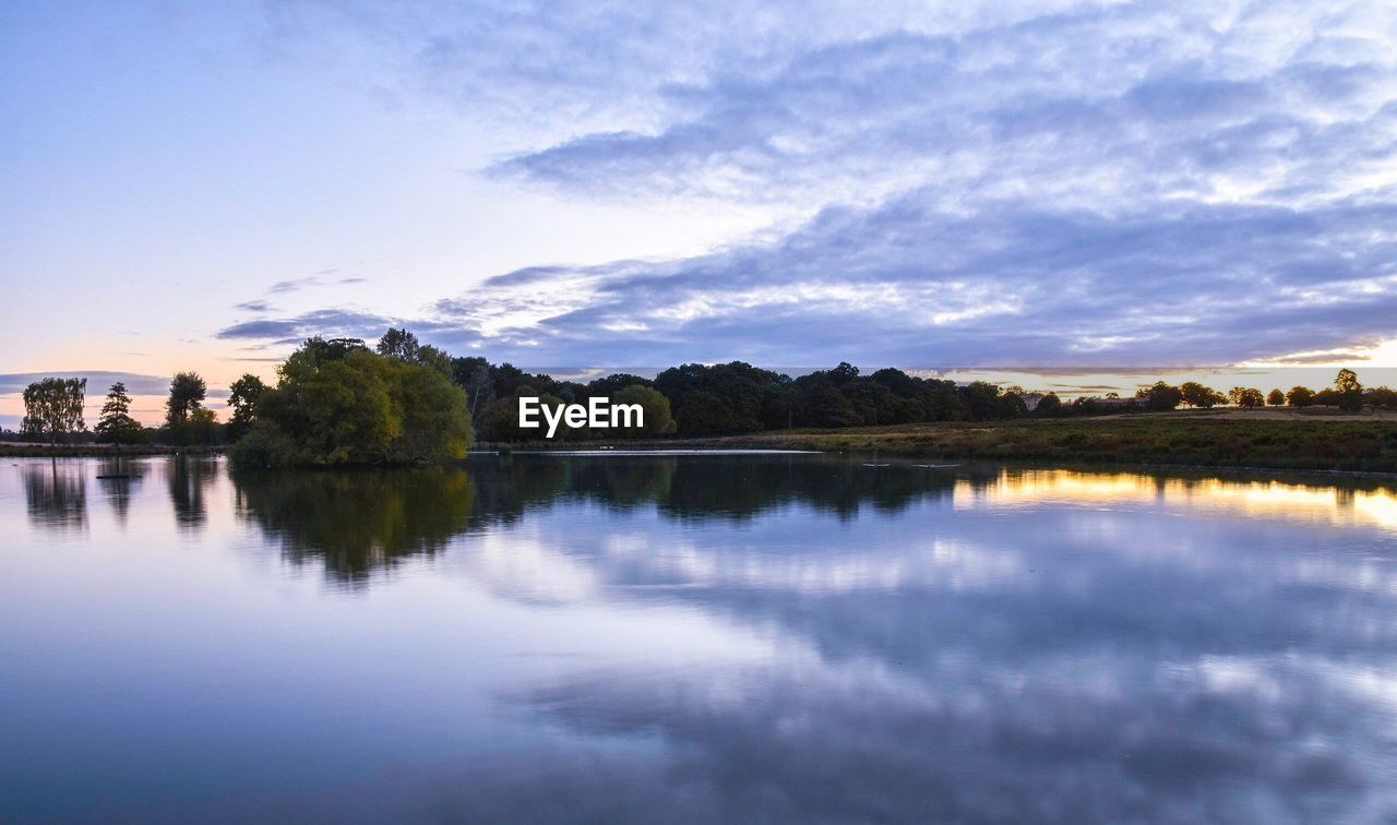 SCENIC VIEW OF CALM LAKE AGAINST SKY