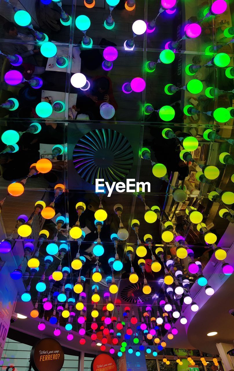 LOW ANGLE VIEW OF ILLUMINATED LIGHTS AT CEILING