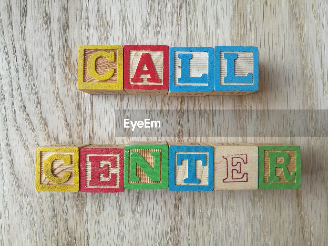 Directly above shot of call center text made from toy blocks on table