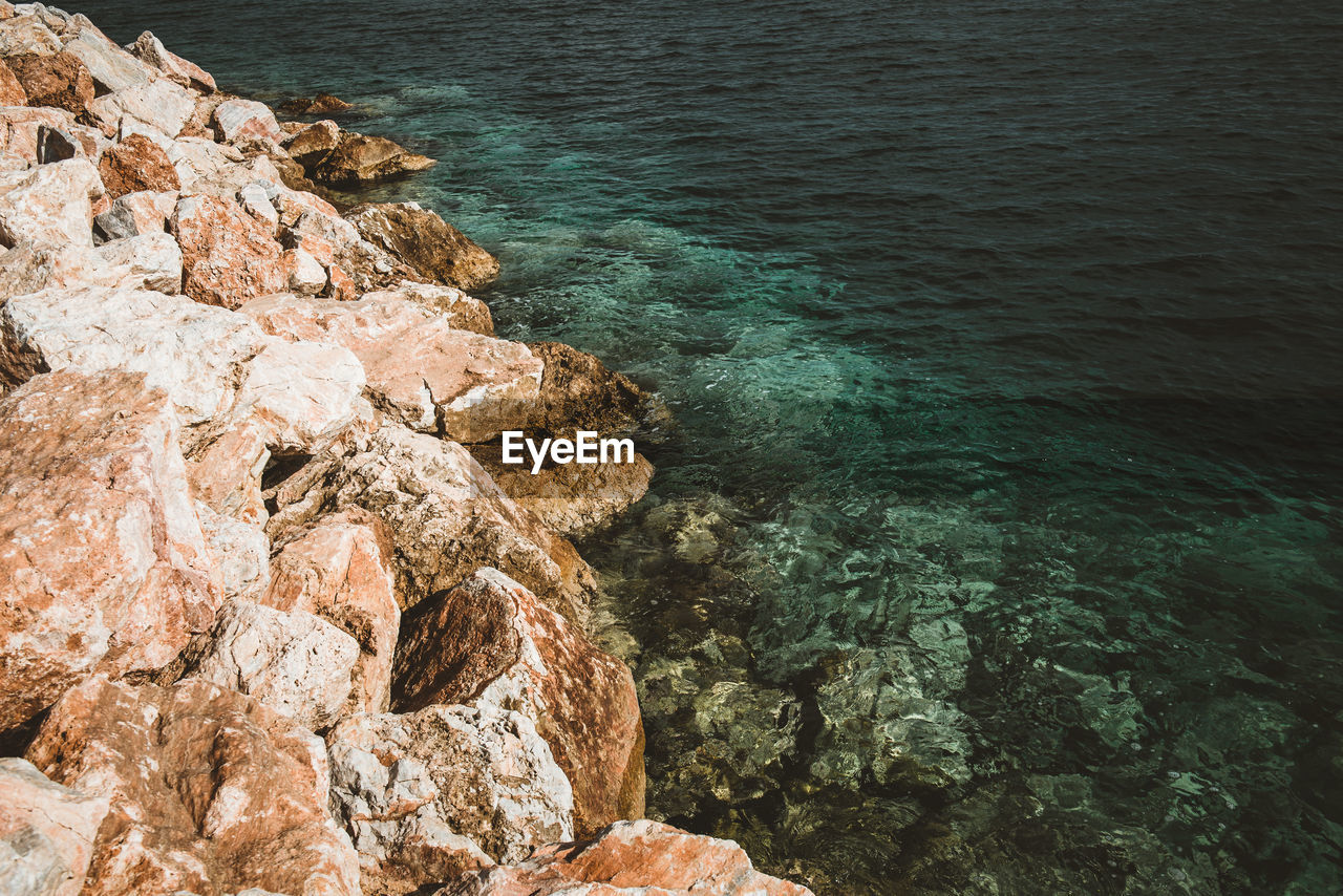 High angle view of rock formation in sea
