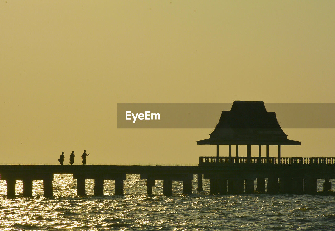 SILHOUETTE PIER ON SEA AGAINST CLEAR SKY