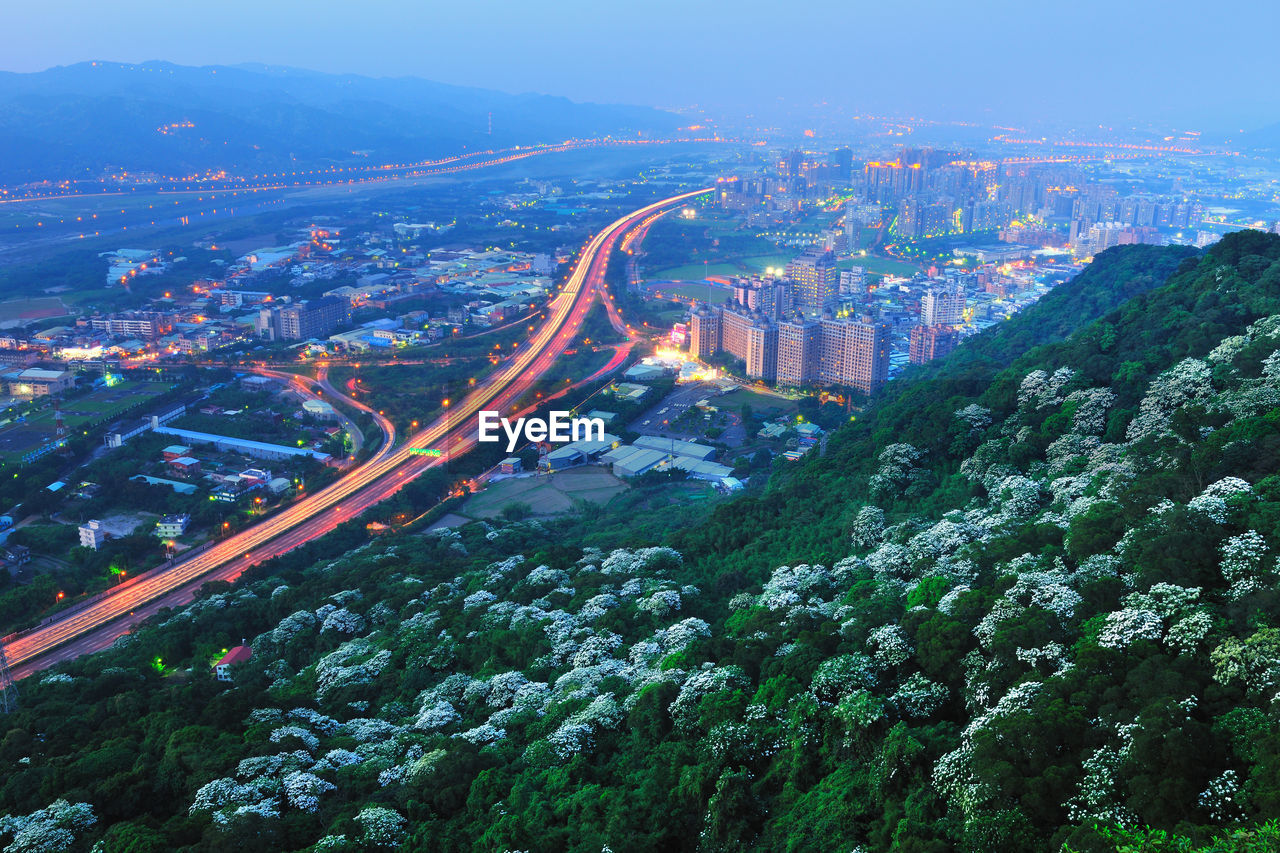 HIGH ANGLE VIEW OF CITYSCAPE AT NIGHT