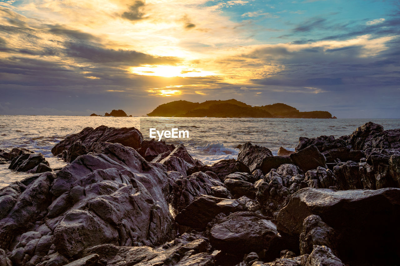 SCENIC VIEW OF ROCKS AT SUNSET